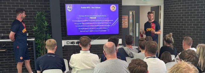 Students and families listening to Exeter Regional Talent Centre presentation